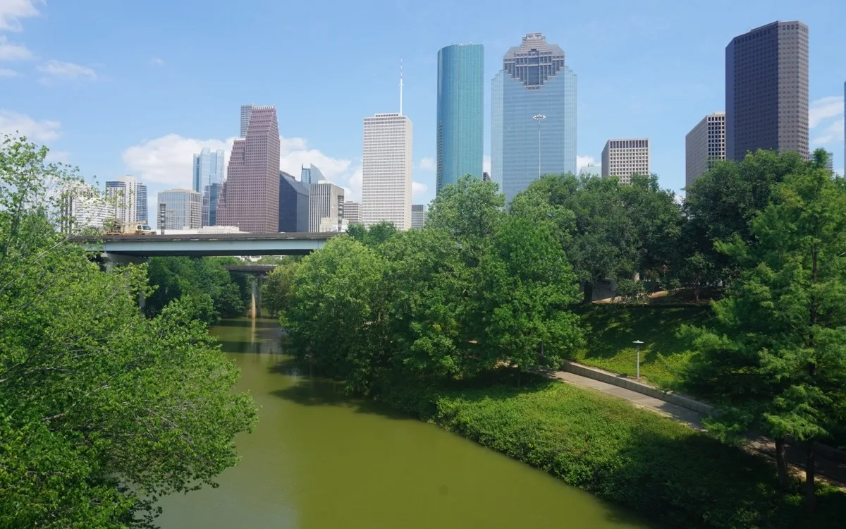 The downtown Houston skyline rising above the green of Buffalo Bayou Park
